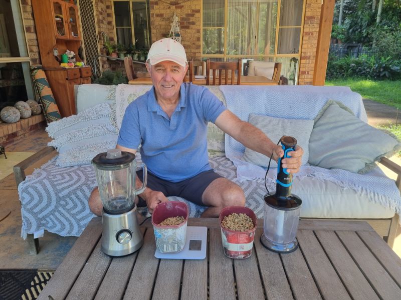 Grower with weighed out parchment coffee and two different blenders.